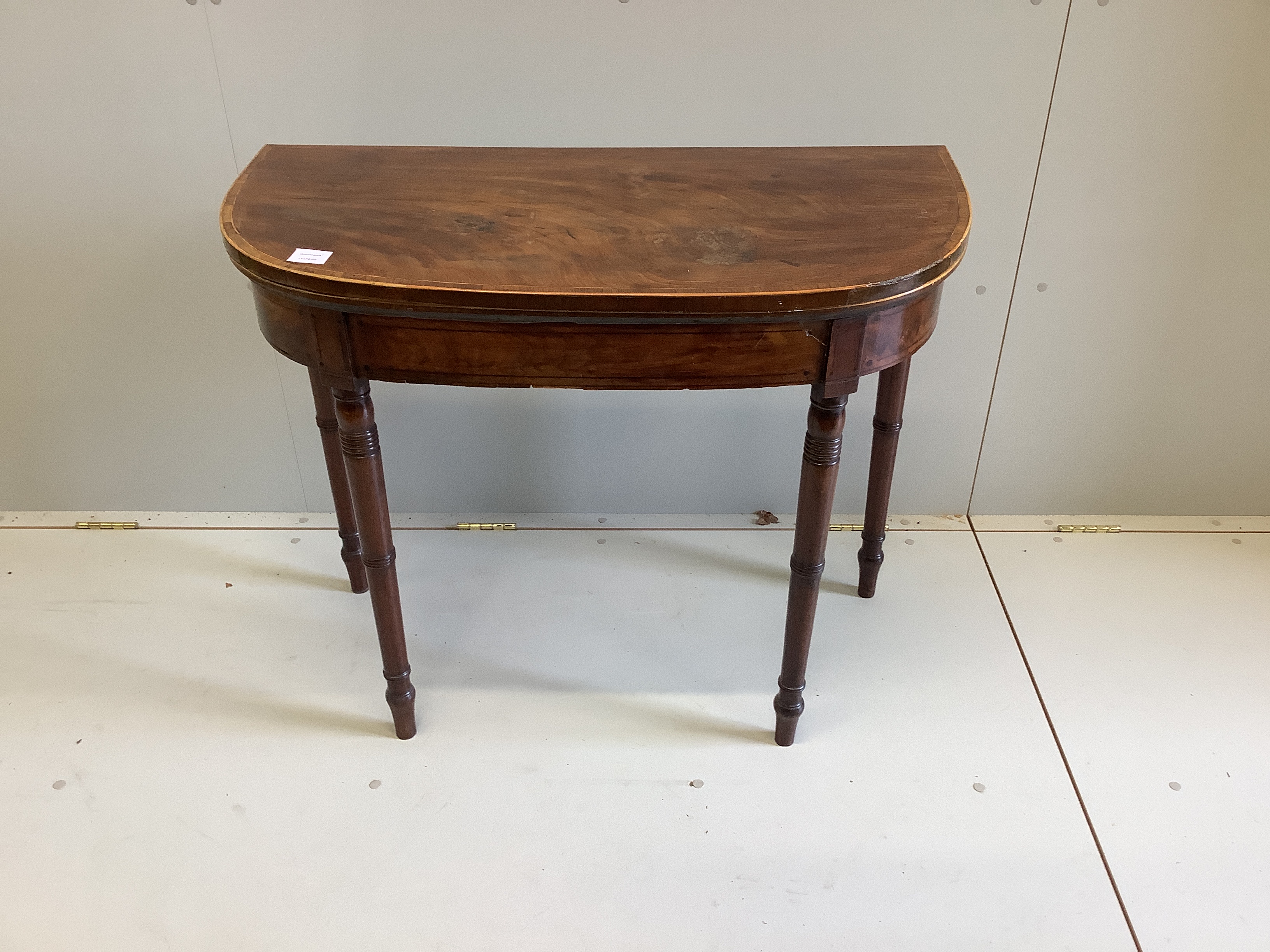 A George III crossbanded mahogany D shaped folding card table, width 91cm, depth 45cm, height 73cm